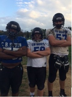 (L to R) Uhuru Kamau, Tommy Merlo, and Louie Graham ready to tackle the next game! Photo from Paige Braun.