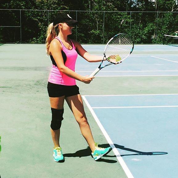 Abby Caddick prepares to serve during a practice tennis match